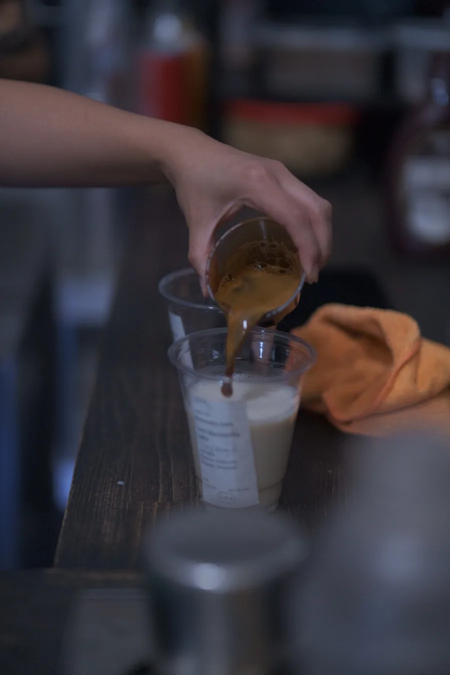 Espresso being poured over iced milk