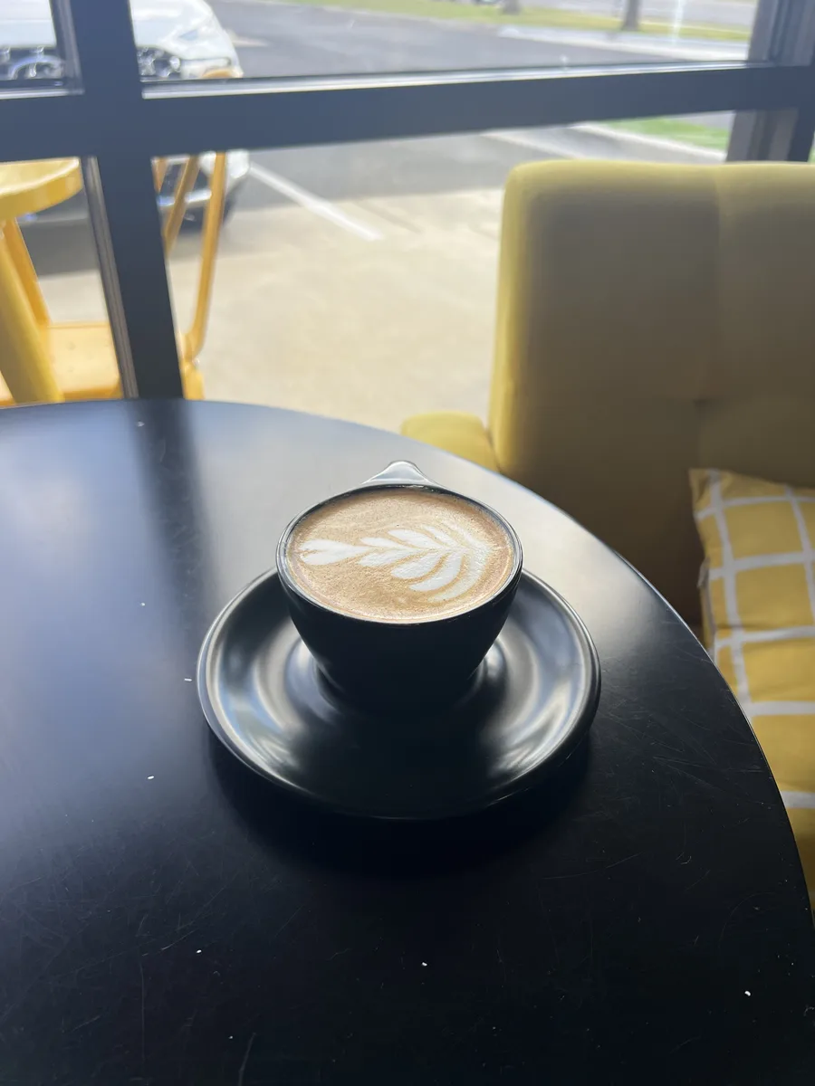 Latte with rosetta art, seen from above
