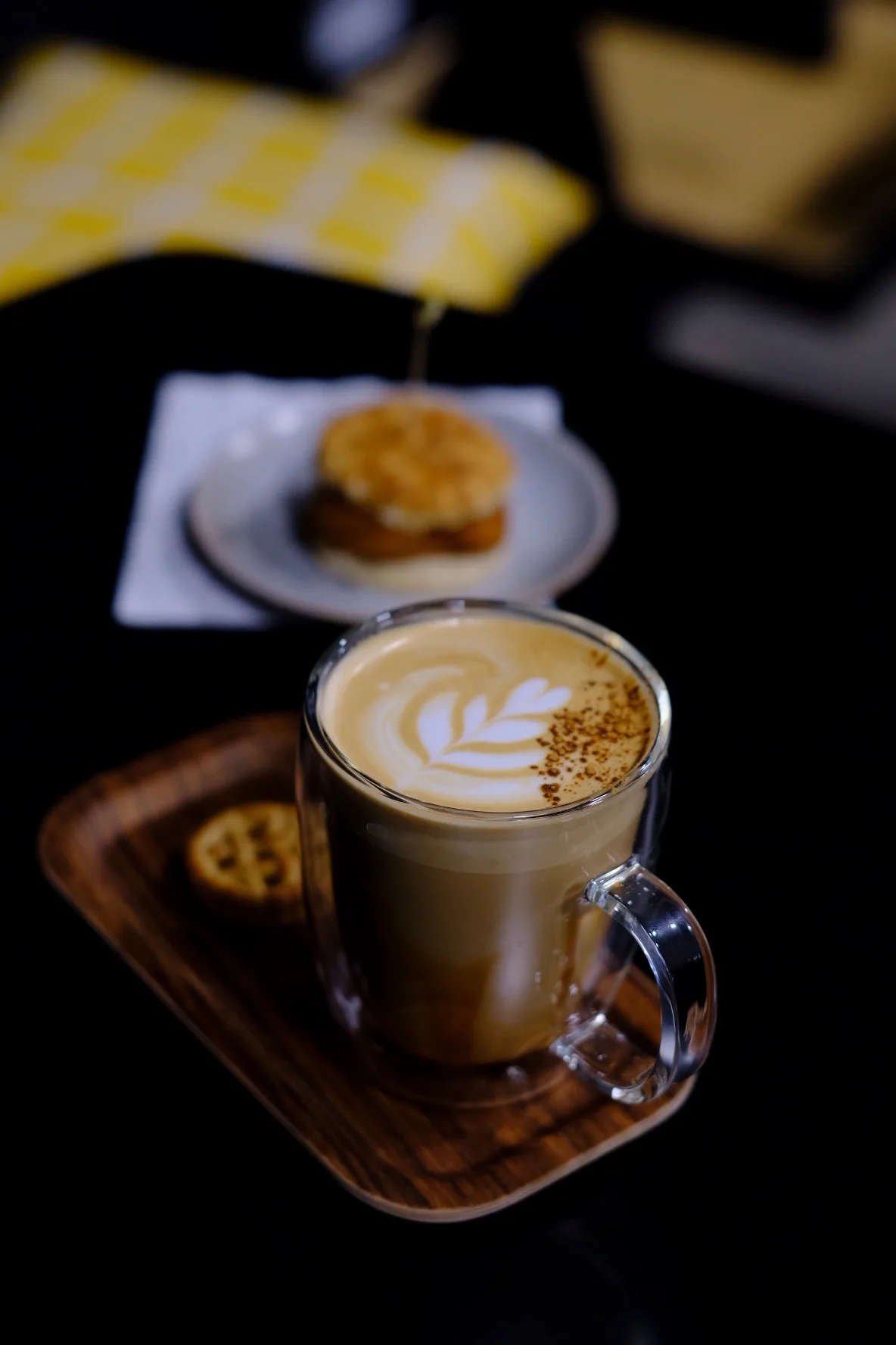Latte with rosetta art in a clear glass mug